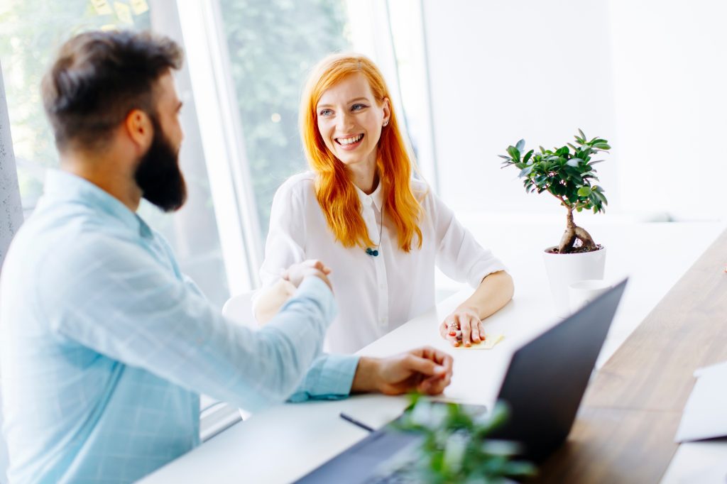 Business people shaking hands and finishing up a meeting